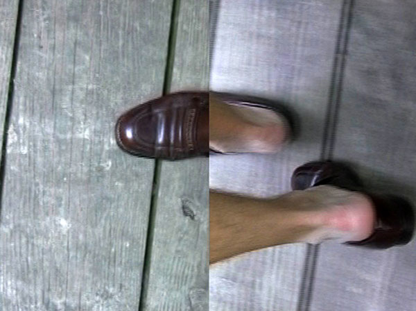 In My Shoes: Urbana, Illinois, 2011, video still, two-channel split screen<br><br>Go to menu, click VIDEOS, to watch excerpts<br><br>In My Shoes puts me at the center of an existential dilemma of wearing community members’ shoes associated with a memorable moment.