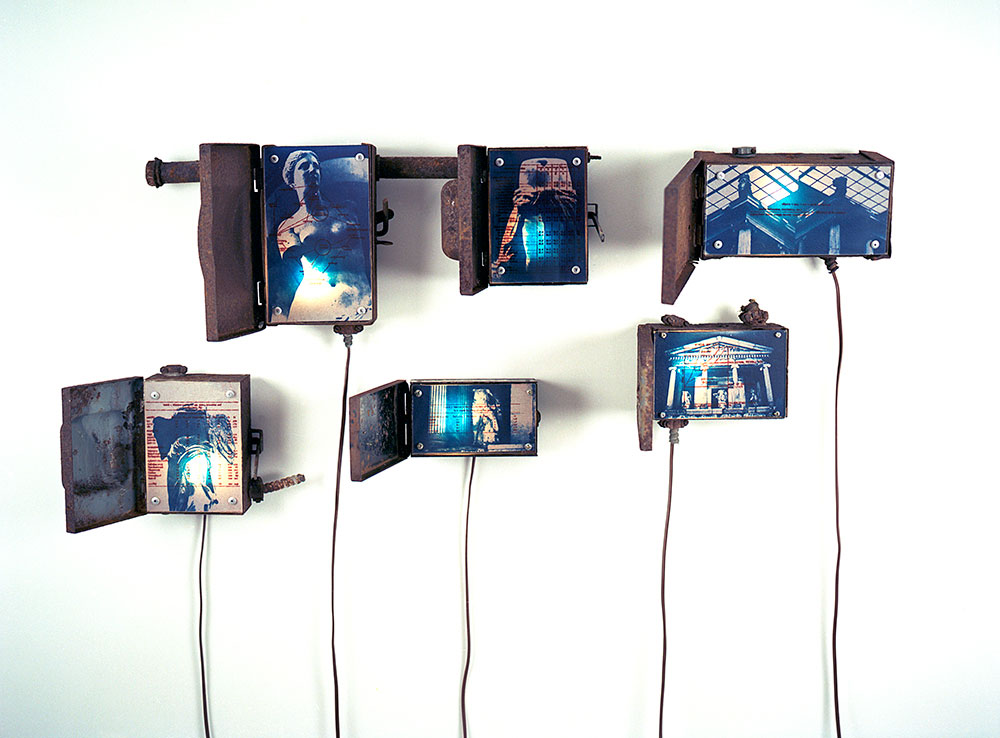 Museum Preservation, 2001, installation view, cyanotype and gum bichromate prints, rusted fuse boxes, lights, 50 x 40<br><br>I overlay classical Greek and Roman sculpture imagery with museum visitor and collection data to examine the blurred interests between preservation and commoditization.