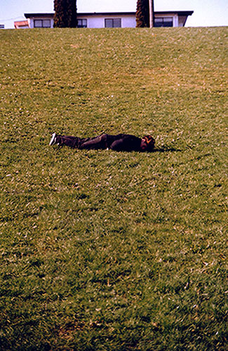 Roll, 2003, color digital print, 11 x 14<br><br>Go to menu, click VIDEOS, to watch excerpts<br><br>During Pre/amble: Festival of Art and Psychogeography, I partake in a dizzying roll down a hill.